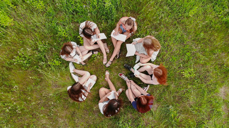 students on lawn in circle